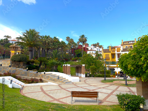 beautiful park and central square with palm trees in La Alcaidesa with nice colorful houses, Cádiz, Andalusia, Malaga, Spain