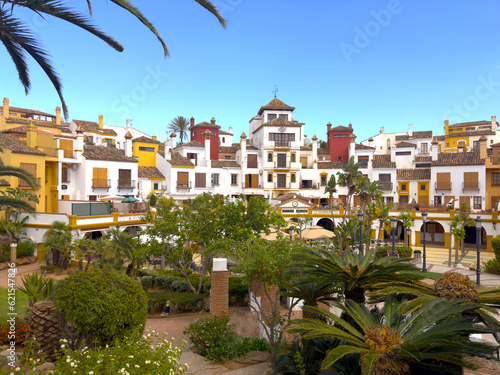 beautiful park and garden with palm trees in the centrum of La Alcaidesa with nice colorful houses, Cádiz, Andalusia, Malaga, Spain photo