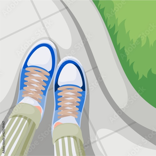 Top view of legs in sneakers on stone sidewalk vector illustration. Cartoon person in pants and sneakers on feet standing on concrete tiles of city road near green lawn, summer walk selfie from above