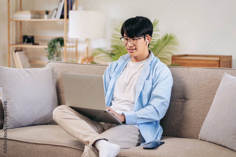 Businessman in casual is sitting on comfortable sofa and wearing Businessman in casual is sitting on comfortable sofa and wearing