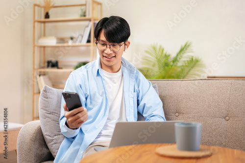 Businessman in casual is sitting on comfortable sofa and wearing photo
