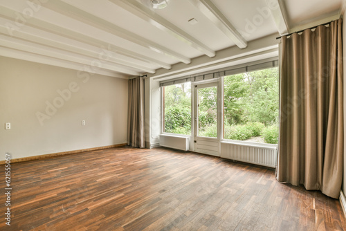 an empty living room with wood flooring and large windows in the room is very clean  ready to use