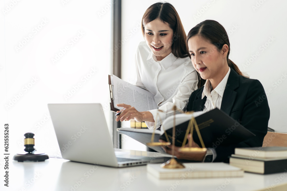 Female lawyer is holding law book and giving advice about laws a Female lawyer is holding law book and giving advice about laws a