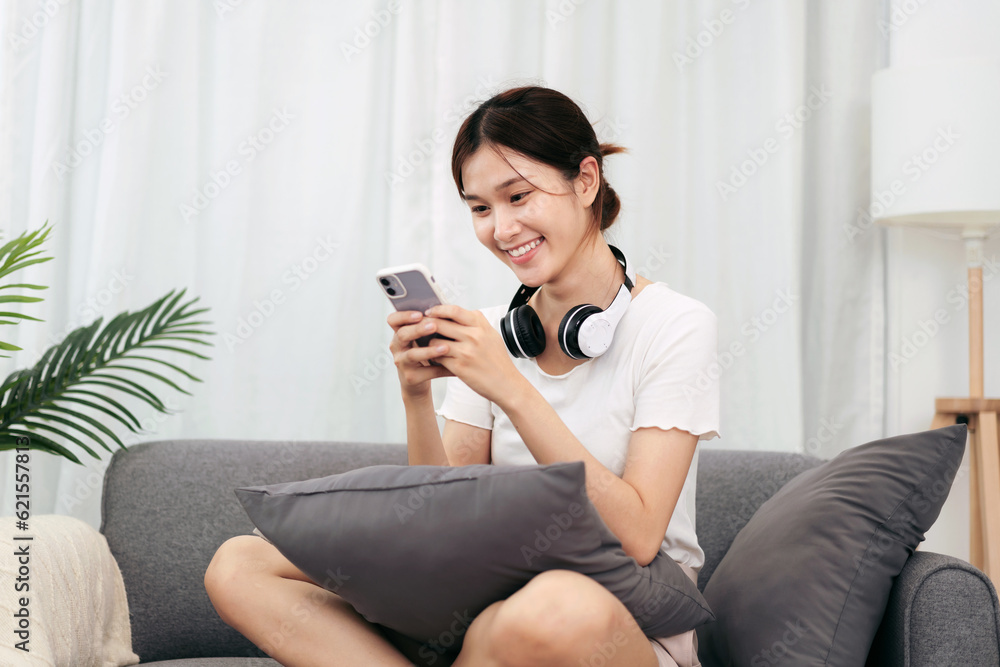 Teenage girl using smartphone to chatting with friends and surf social media while sitting comfortable Teenage girl using smartphone to chatting with friends and surf social media while sitting comfortable