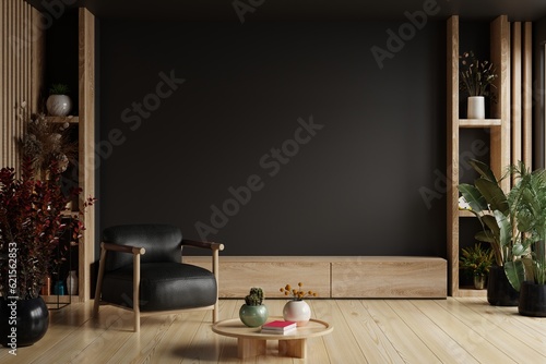 TV room interior with black leather armchair on empty dark wall background.