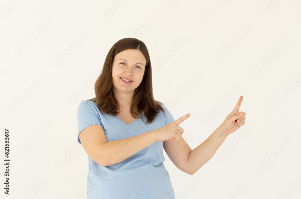 Professional smiling young woman help customer find where go, showing way, pointing finger right and grinning friendly, pleased to answer any questions as introduce new product, white background Professional smiling young woman help customer find where go, showing way, pointing finger right and grinning friendly, pleased to answer any questions as introduce new product, white background