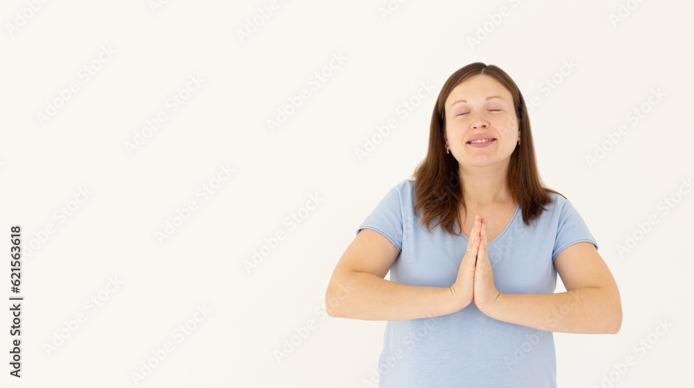 Worried young woman praying god with folded hands teenager girl asking god for help Pretty young business woman beg for mercy with eyes closed Isolated on white background Worried young woman praying god with folded hands teenager girl asking god for help Pretty young business woman beg for mercy with eyes closed Isolated on white background