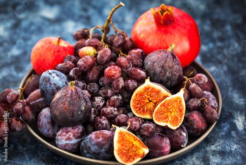 Fresh autumn fruits -  figs, plums, grapes and pomegranate
