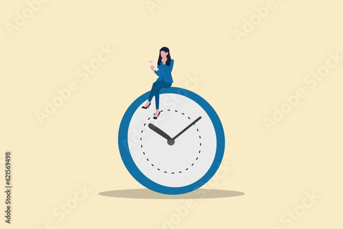 Business woman using gadget sitting on clock. concept working late night with deadline