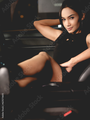 Beautiful woman posing with a car
