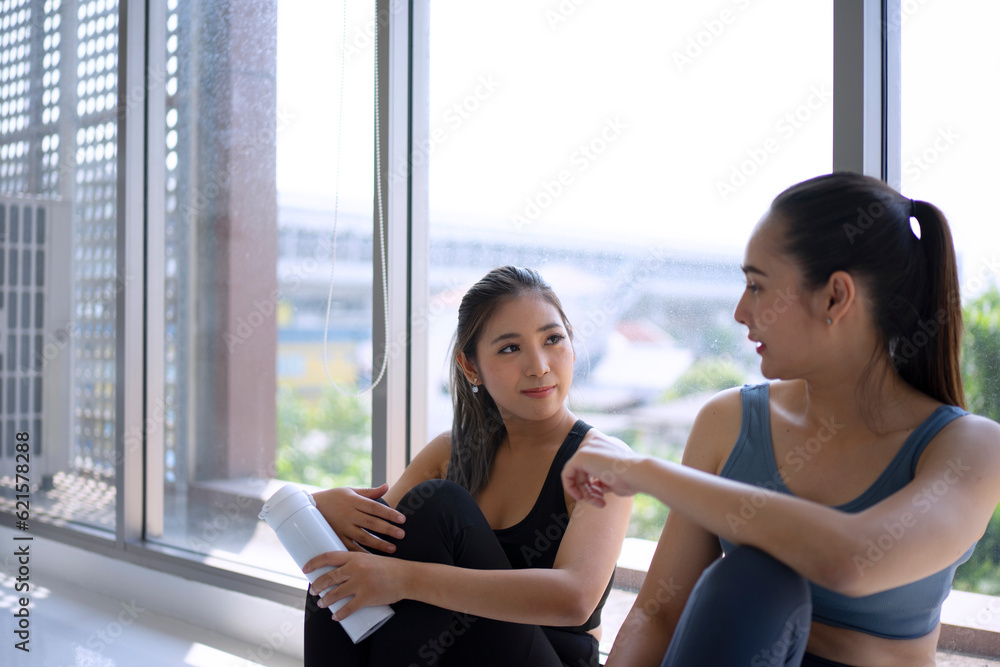 Women play yoga at home. Healthy lifestyle and friendship concept