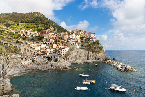 Scenic view of Manarola village, one of the five villages along Cinque Terre hiking trail in Italy, popular as tourist destination