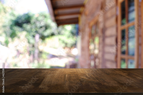 Empty wooden table in front of abstract blurred background of coffee shop . can be used for display or montage your products.Mock up for display of product. © Charlie's