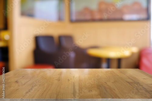 Empty wooden table in front of abstract blurred background of coffee shop . can be used for display or montage your products.Mock up for display of product.