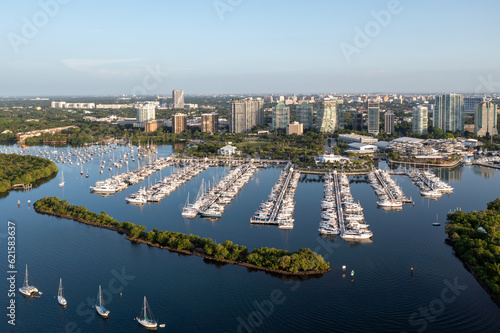 Aerial view of Dinner Key Marina and City of Miami City Hall with Coconut Grove  Miami skyline in background on calm sunny clear summer morning.