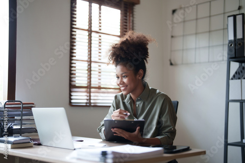 Young afro african american millennial entrepreneur working with financial documents.. photo