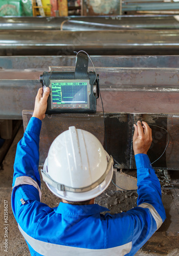Inspectors are Inspection defects in Welded Steel H-beam add joints with Process Ultrasonic Testing (UT) of Non-Destructive Testing (NDT)