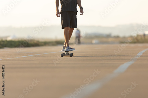 Man skating on the street by the beach