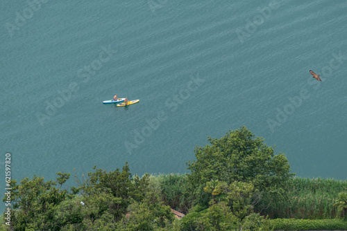 Aerial view of Lake Lugano, Switzerland, with two women using a stand up paddle photo