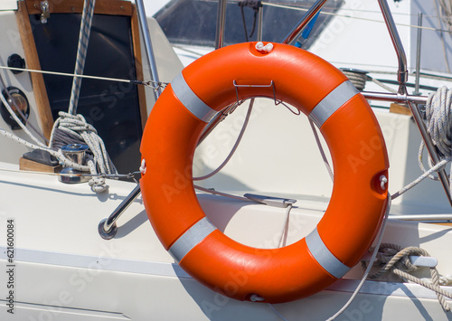 Orange lifebuoy on a yacht on a summer day. Safety on the water. Tourism, cruises
