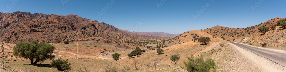 Great panoramic landscape of the Anti-Atlas mountains in the Taourirt region, a road winding through the mountains