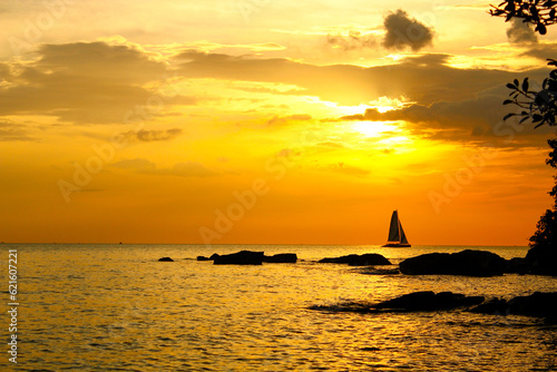 Sunset with sailboat on the Otres beach. Sihanoukville, Cambodia photo