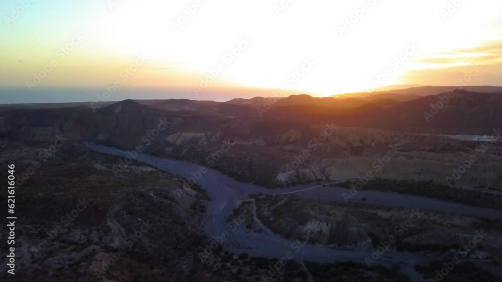Aerial Tilt Up Shot Of Mountain Ranges Against Orange Sky At Sunset, Drone Flying Over Landscape - Baja California, Mexico Aerial Tilt Up Shot Of Mountain Ranges Against Orange Sky At Sunset, Drone Flying Over Landscape - Baja California, Mexico