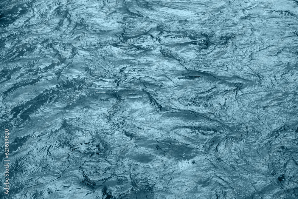 Obraz premium Abstract underwater wallpaper. Aquatic ripple wavy blue water surface, water texture background, top view.