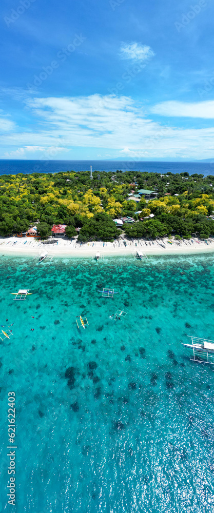 Beautiful beaches and hopping boats on Balikasak Island, Bohol, Philippines, a sacred place for scuba diving (traditional Philippine boats, banca)
