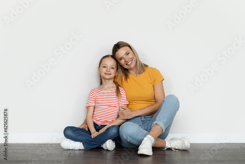 Mother And Daughter. Happy Loving Family Mom And Female Child Embracing And Smiling