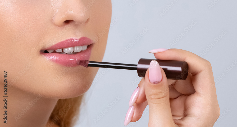 Portrait of a beautiful blonde teenager girl with long hair, beautiful fresh makeup and healthy clean skin. She do lips make-up.Professional makeup and cosmetology skin care. Portrait of a beautiful blonde teenager girl with long hair, beautiful fresh makeup and healthy clean skin. She do lips make-up.Professional makeup and cosmetology skin care.