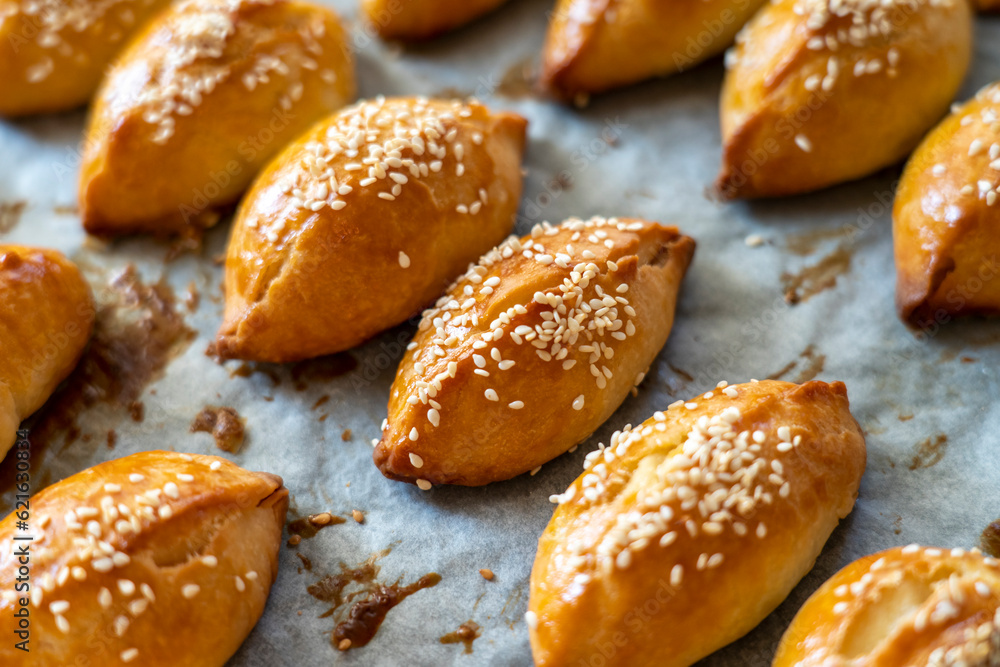 Turkish pastry pogaca with cheese filling on oven tray Turkish pastry pogaca with cheese filling on oven tray