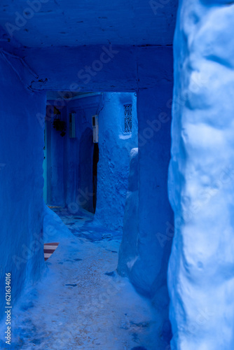 Vibrant blue colored wooden door in downtown Chefchaouen © imagoDens
