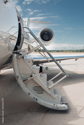 Open airstairs of a private jet at the airport. Luxury business jet  photo