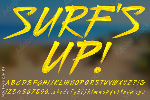 Surf's Up! A bright yellow paint brush script alphabet in surfer style.