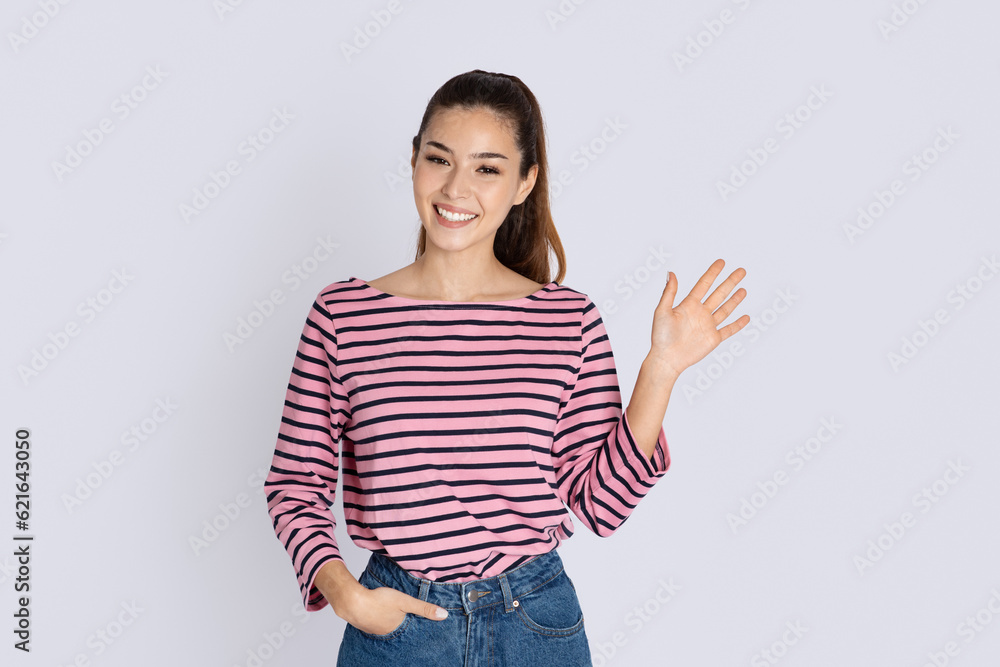 Positive cool young brunette woman waving at camera Positive cool young brunette woman waving at camera