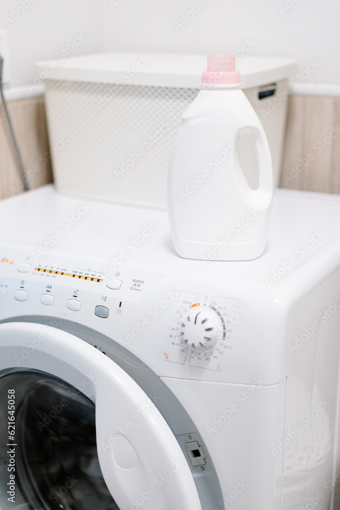 Washing gel liquid laundry detergent and fabric softener on washing machine. High quality photo Washing gel liquid laundry detergent and fabric softener on washing machine. High quality photo