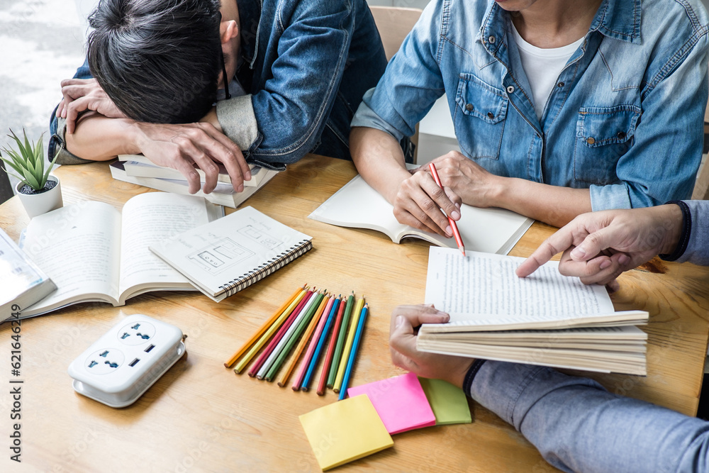 High school tutor or college student group sitting at desk in library studying and reading, doing homework and lesson practice preparing exam to entrance, education, teaching, learning concept High school tutor or college student group sitting at desk in library studying and reading, doing homework and lesson practice preparing exam to entrance, education, teaching, learning concept