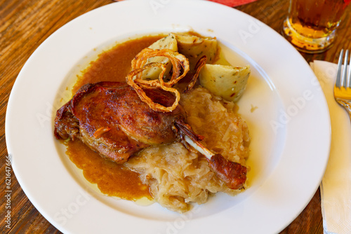 Czech cuisine,confit duck leg with potato dumplings, sauerkraut and onion