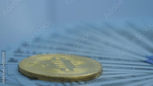 A close up view of a Bitcoin on 100 dollar bills. photo