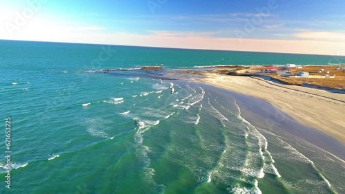 Aerial Shot Of Man Kitesurfing On Turquoise Sea Waves, Drone Flying Forward Over Coastline On Sunny Day - Baja California, Mexico