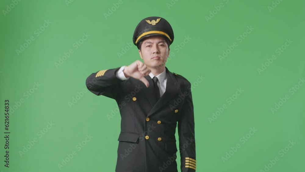 Asian Man Pilot Showing Thumbs Down Gesture To Camera While Standing In The Green Screen Background Studio
Asian Man Pilot Showing Thumbs Down Gesture To Camera While Standing In The Green Screen Background Studio