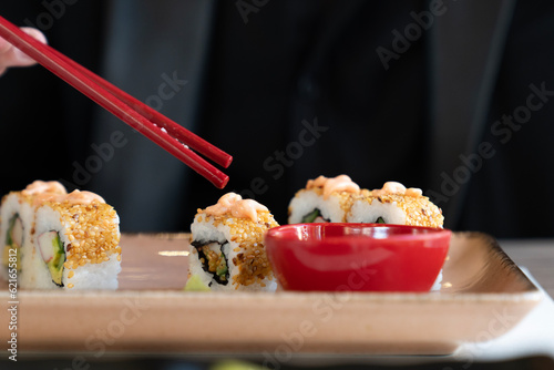 woman eating sushi at Japanese restaurant