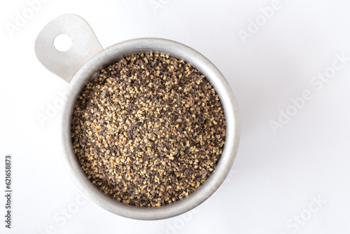 GrouGround Black Pepper in a Measuring Cupnd Black Pepper in a Measuring Cup