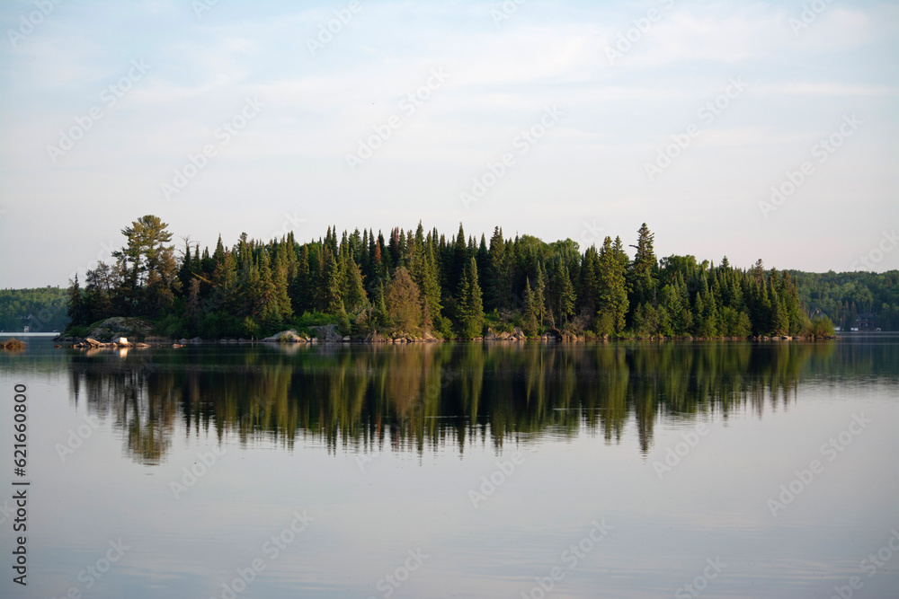 reflection of an island on a lake