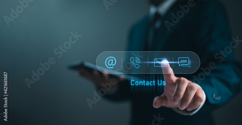 Contact us or Customer support hotline, people connect. Businessman touching on virtual screen contact icons (email, address, live chat, telephone). Customer service, helpdesk advice online support