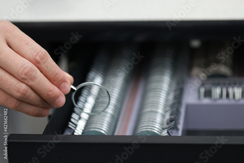 Optometry, hands, and trial lenses for a eye test for vision, eyecare and healthcare in a optic clinic. Eyewear, glasses and optician or ophthalmologist choosing a prescription lens in a optical store