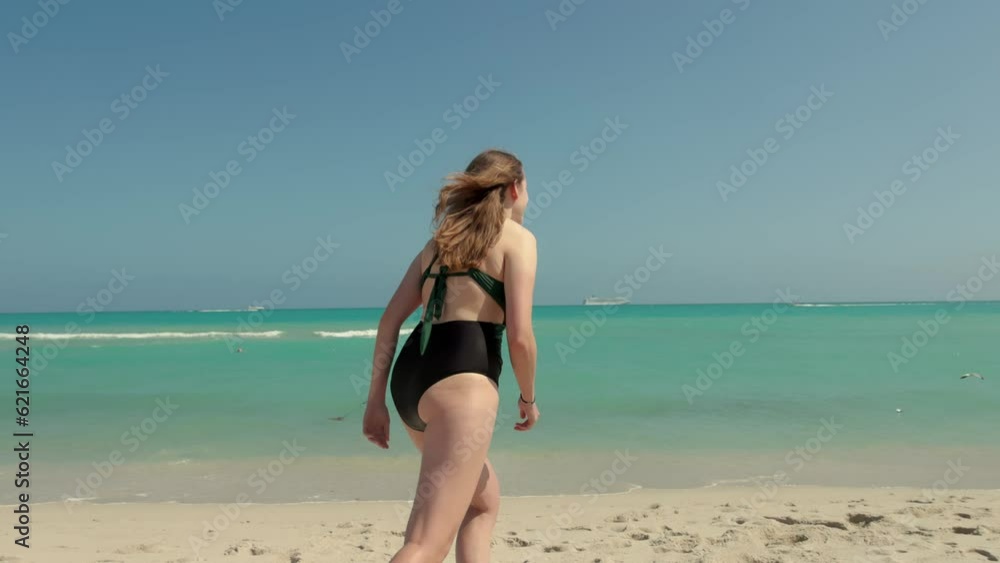 Beautiful girl wearing a bikini at Miami Beach running into the ocean water in extreme slow motion - Miami Florida travel photography Beautiful girl wearing a bikini at Miami Beach running into the ocean water in extreme slow motion - Miami Florida travel photography