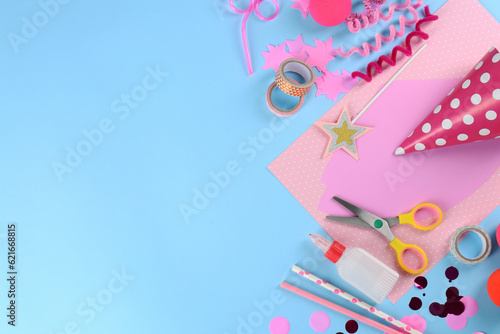 Flat lay composition with different materials to create party hats on light blue background, space for text. Handmade decoration