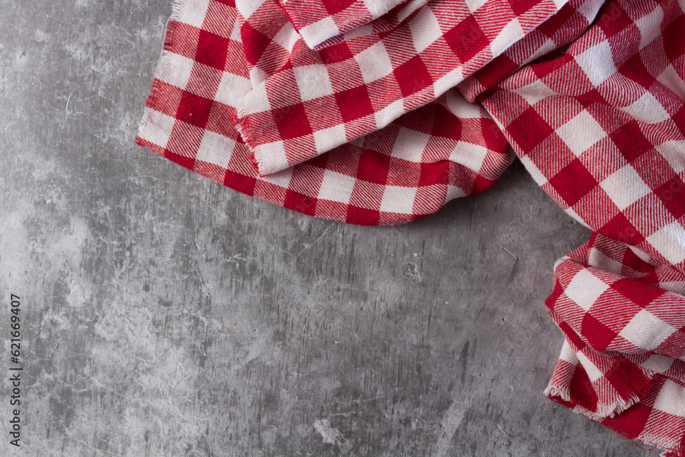 Red and white tablecloth on concrete table Red and white tablecloth on concrete table